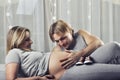 Happy daddy holding pregnant wifeÃ¢â¬â¢s belly and smiling Royalty Free Stock Photo